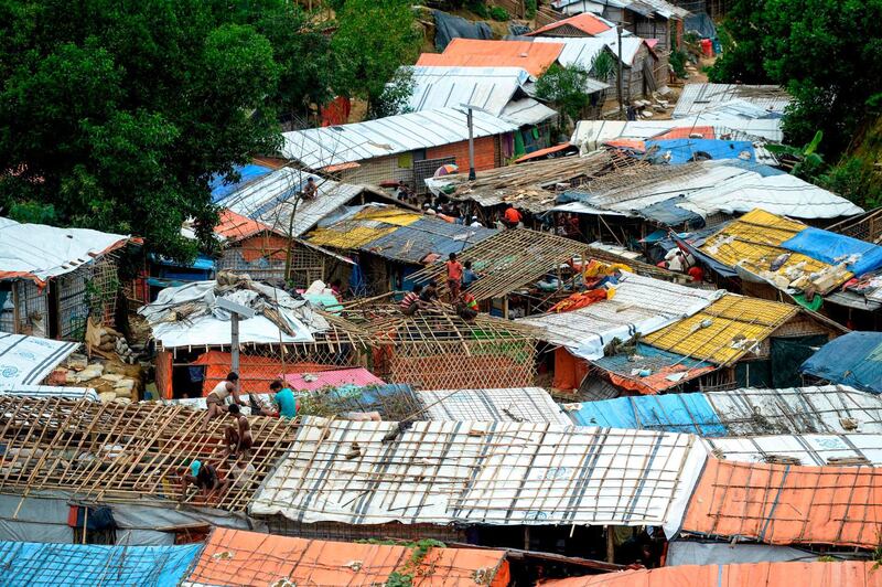 Rohingya refugees renovate makeshift houses at Kutupalong refugee camp in Ukhia district on August 23, 2019. / AFP / MUNIR UZ ZAMAN

