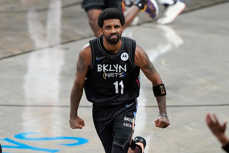 Brooklyn Nets' Kyrie Irving (11) celebrates after making a 3-point basket during the second half of an NBA basketball game against the New York Knicks Monday, April 5, 2021, in New York. (AP Photo/Frank Franklin II)
