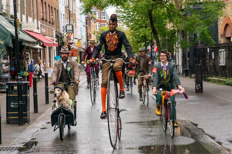 Riders take part in the annual Tweed Run cycling event in London on Saturday, April 27. PA