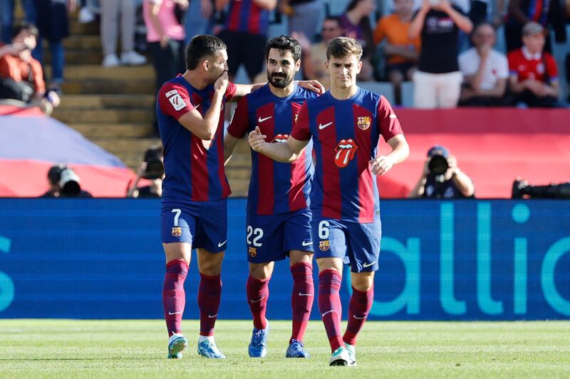Barcelona's Ilkay Gundogan, centre, celebrates with Barcelona's Ferran Torres, left, and Barcelona's Gavi after scoring his side's opening goal. AP