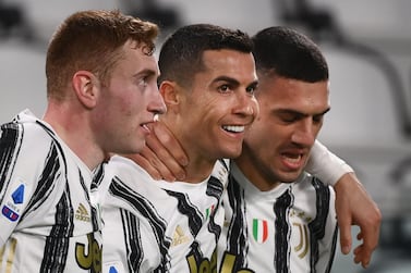 Juventus' Portuguese forward Cristiano Ronaldo (C) celebrates with Juventus' Swedish forward Dejan Kulusevski (L) and Juventus' Turkish defender Merih Demiral after scoring his second goal during the Italian Serie A football match Juventus vs Crotone on February 22, 2021 at the Juventus stadium in Turin. / AFP / Marco BERTORELLO