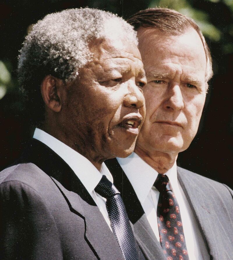 South African anti-apartheid leader and African National Congress (ANC) member Nelson Mandela (L) speaks to the press and fans 25 June 1990 after finishing his joint statement with U.S. President George Bush senior (R) on the White House South Lawn.
(FILM)  AFP PHOTO/KEVIN LARKIN