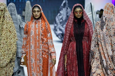Models display creations by Barli Asmara during the Muslim Fashion Festival in Jakarta, Indonesia, Friday, May 3, 2019. The event was held to greet the upcoming holy fasting month of Ramadan. (AP Photo/Achmad Ibrahim)