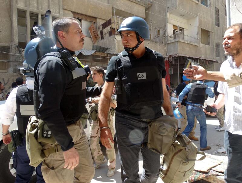 United Nations arms experts inspect the site of a suspected chemical weapons attack the Damascus suburb of Ghouta last month. Mohamed Abdullah / AFP

