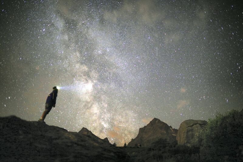 A photographer prepares to take pictures of the annual Perseid meteor shower in the village of Crissolo, near Cuneo, in the Monviso Alps region of northern Italy, on August 13, 2015. The Perseid meteor shower occurs every year when the Earth passes through the cloud of debris left by Comet Swift-Tuttle. AFP PHOTO / MARCO BERTORELLO / AFP PHOTO / MARCO BERTORELLO
