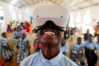 Francis Mwangi, 13, uses an Oculus virtual reality (VR) headset, to virtually visit Buckingham Palace, in Nyeri, Kenya. Reuters