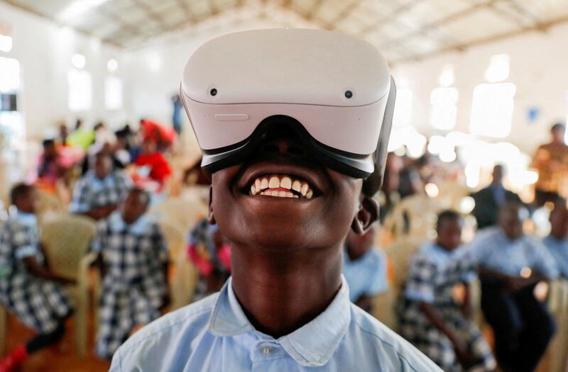 Francis Mwangi, 13, uses an Oculus virtual reality headset to  visit Buckingham Palace virtually during platinum jubilee celebrations in Nyeri, Kenya. Reuters