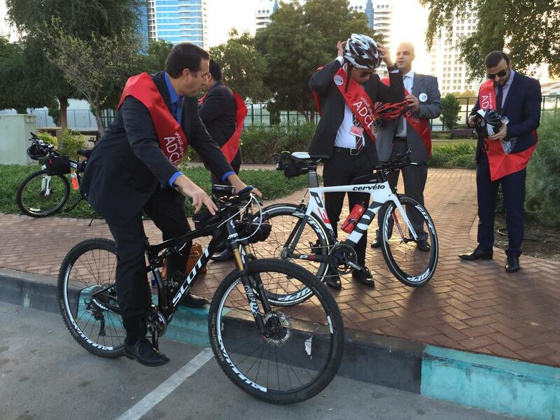 Riders from ADCB gear up before cycling to work from Heritage Park in Abu Dhabi. Christopher Pike / The National