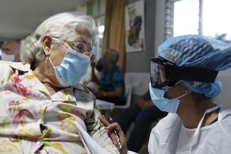 An elderly woman receives the Sinovac vaccine against Covid-19 at a nursing home during the start of vaccination for those over 80 in Medellin, Colombia. EPA