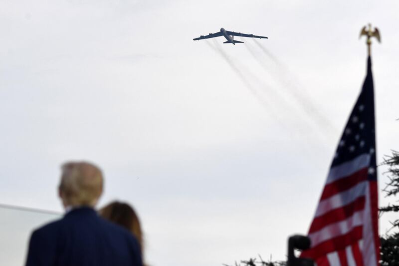 (FILES) In this file photo taken on July 04, 2020, US President Donald Trump (L) and First Lady Melania Trump (2nd L) watch a B-52 bomber flyover during the 2020 Independence Day on the South Lawn of the White House. - Iran's Foreign Minister Mohammad Javad Zarif on December 31, 2020, accused US President Donald Trump of aiming to fabricate a "pretext for war" as tensions mount between the two countries. His remarks come ahead of the first anniversary of the US killing of top Iranian military commander Qasem Soleimani in a drone strike in Baghdad on January 3. The Nimitz has been patrolling Gulf waters since late November 2020 and two US B-52 bombers recently overflew the region on December 30. (Photo by SAUL LOEB / AFP)