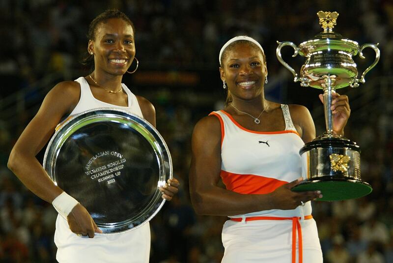 MELBOURNE - JANUARY 25:  Serena Williams of the USA  (R) holds the winners trophy and her sister  Venus Williams of the USA holds the runners up trophy after the Women's Singles final during the Australian Open Tennis Championships at Melbourne Park, Melbourne, Australia on January 25, 2003. (Photo by Sean Garnsworthy/Getty Images).