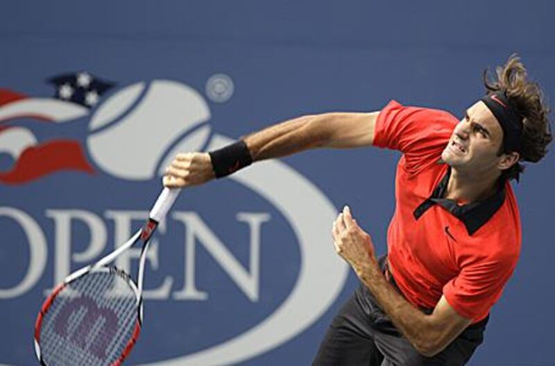 Roger Federer, of Switzerland, serves to Tommy Robredo, of Spain, at the U.S. Open tennis tournament in New York.