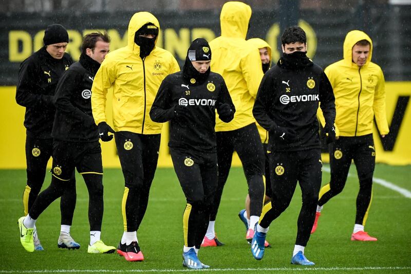 Dortmund's Tobias Raschl (C) and Giovanni Reyna (second right) attend a training session in Dortmund, Germany. EPA