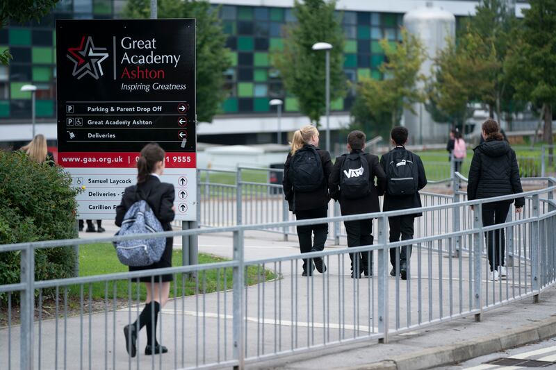 Year 7 pupils arrive at Great Academy Ashton in Manchester as schools reopen after the summer holidays. AP Photo