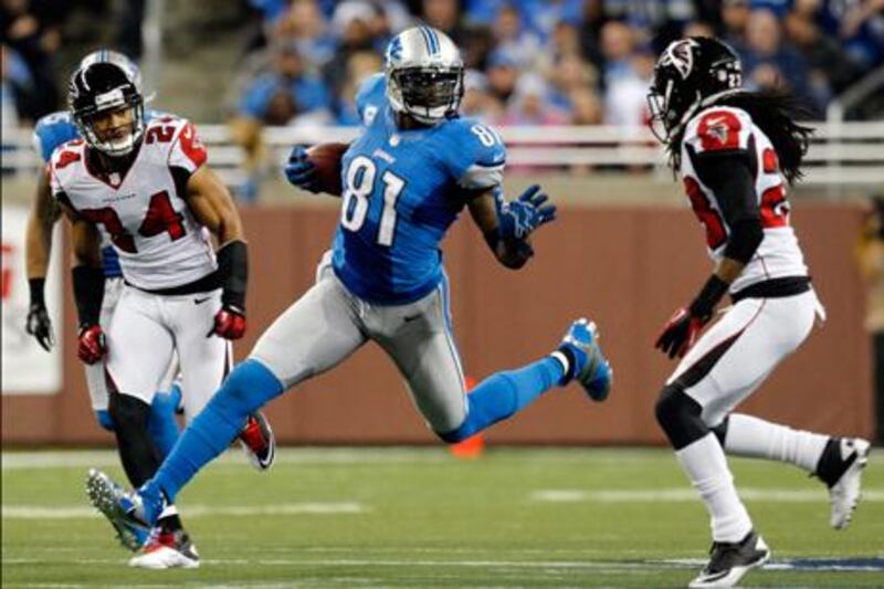 Detroit Lions' wide receiver Calvin Johnson finds a way between Atlanta's Chris Hope and Dunta Robinson.