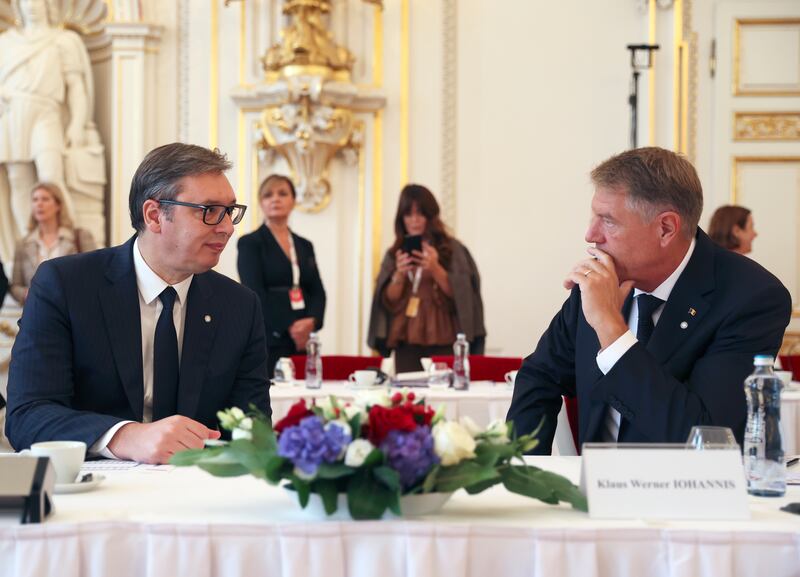 Serbian President Aleksandar Vucic deep in discussion with Romania's President Klaus Werner Iohannis. EPA