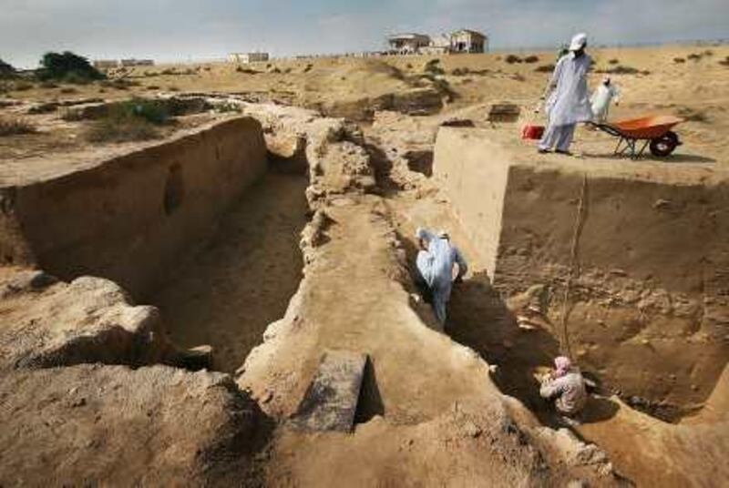 Sharjah, United Arab Emirates --- January 5, 2010 --- Archaeologists and workers clear bedrock at the Muwaileh Archaeological site in Sharjah. According to archaeologist Peter Magee, underneath the site is water but a critical issue is how accessible is the ground water. ( Delores Johnson / The National ) *** Local Caption ***  dj_05jan10_na_archaeological_012.jpg