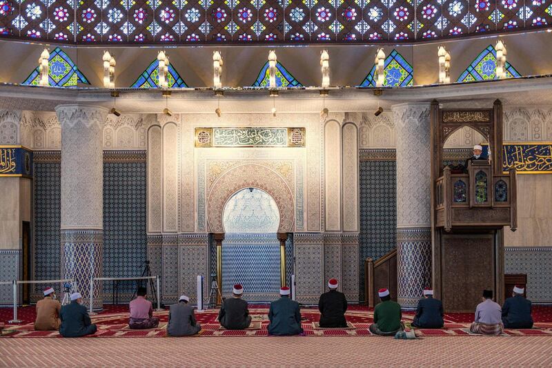 Mosque staff listen to a Friday sermon in Kuala Lumpur.  AFP