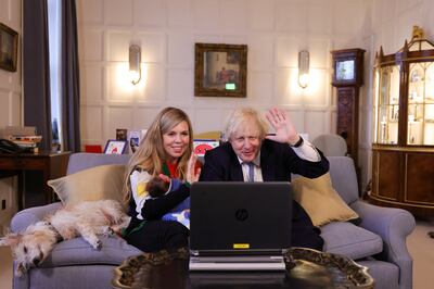 British Prime Minister Boris Johnson and his wife Carrie with their daughter Romy, pictured at Chequers just before Christmas. He is facing a vote of no confidence in his leadership. Reuters
