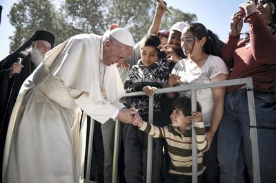 MYTILENE, GREECE - APRIL 16:  In this handout image provided by Greek Prime Minister's Office, Pope Francis meets migrants at the Moria detention centre on April 16, 2016 in Mytilene, Lesbos, Greece. Pope Francis will visit migrants at the Moria camp on the Greek island of Lesbos along with Greek Orthodox Ecumenical Patriarch Bartholomew I and Archbishop of Athens and All Greece, Ieronimos II.  (Photo by Andrea Bonetti/Greek Prime Minister's Office via Getty Images)