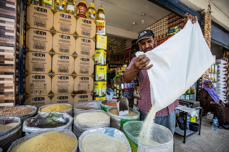 A merchant sells grains at a market in Qamishli, in north-east Syria. AFP