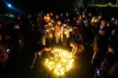 People attend a candlelit vigil at Belfairs Recreation Ground near the church where British MP Sir David Amess was killed. PA