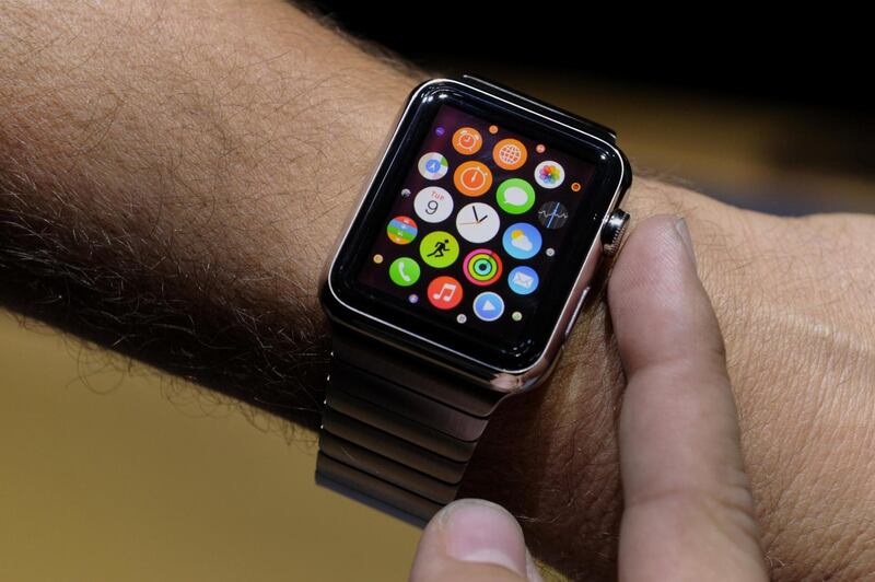 An attendee demonstrates the Apple Watch after a product announcement at Flint Center in Cupertino, California, U.S., on Tuesday, Sept. 9, 2014. Apple Inc. unveiled redesigned iPhones with bigger screens, overhauling its top-selling product in an event that gives the clearest sign yet of the company's product direction under Chief Executive Officer Tim Cook. Photographer: David Paul Morris/Bloomberg