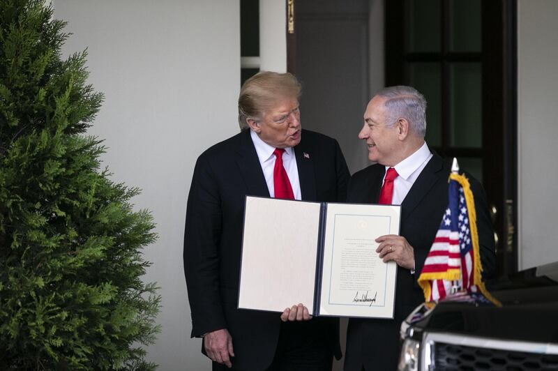 Benjamin Netanyahu, Israel's prime minister, holds up a signed proclamation while speaking with U.S. President Donald Trump, left, after a meeting at the White House in Washington, D.C., U.S., on Monday, March 25, 2019. Trump officially recognized Israeli sovereignty over the Golan Heights Monday in a ceremony with Netanyahu, delivering a symbolic boost to the Israeli prime minister just two weeks before he faces a re-election vote. Photographer: Al Drago/Bloomberg