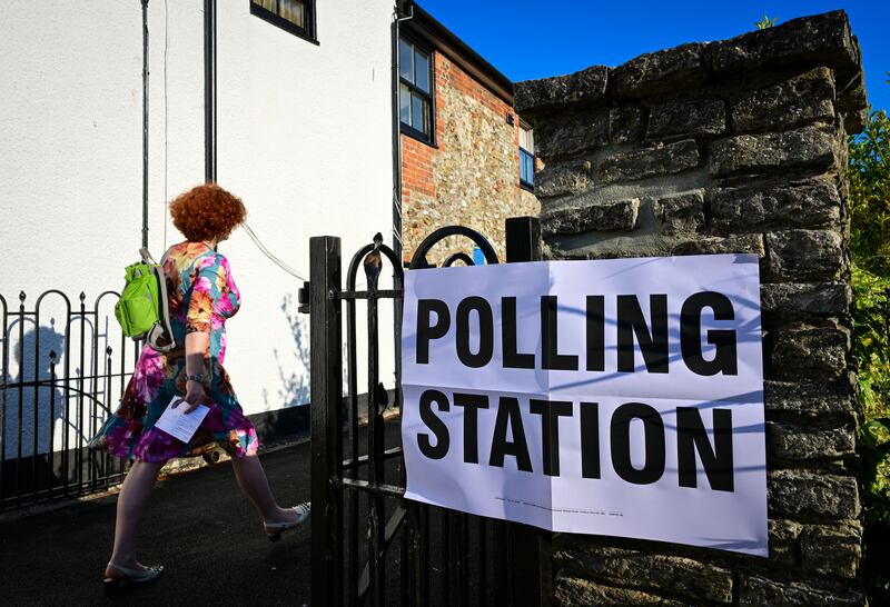 Voters walk to Mackarness Hall in Honiton. The Tiverton and Honiton constituency covers a cluster of villages and market towns surrounded by farmland in Devon. Getty Images