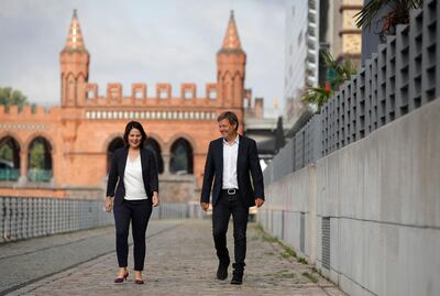 (FILES) This file photo taken on August 31, 2020 shows the co-leaders of Germany's Green party Annalena Baerbock (L) and Robert Habeck walking along the river Spree as they arrive for a closed meeting with the Greens' leadership in Berlin. Germany's Green party on Monday, April 19, 2021 named its co-chair Annalena Baerbock as their candidate to succeed Angela Merkel, throwing down the gauntlet to the chancellor's conservatives who were locked in increasingly vicious infighting for her crown. / AFP / Odd ANDERSEN
