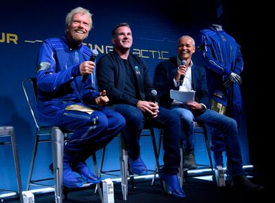 (L to R) Virgin Galactic Founder Sir Richard Branson, Under Armour CEO Kevin Plank and Commercial director of Virgin Galactic Stephen Attenborough watch a presentation  at an event October 16, 2019 in Yonkers, New York.  At the event Virgin Galactic and Under Armour unveiled the world’s first exclusive spacewear system for private astronauts. / AFP / Don Emmert
