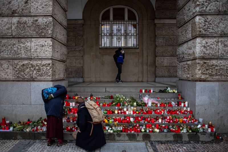 Mourners pay respects at Charles University after a gunman fatally shot 14 people and then killed himself. EPA