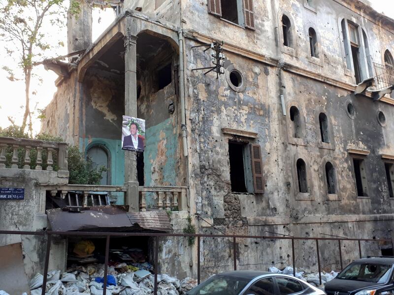 <p>A lonely poster hangs in Basta in Beirut, amid the rubbish and delapidated buildings. India Stoughton</p>

