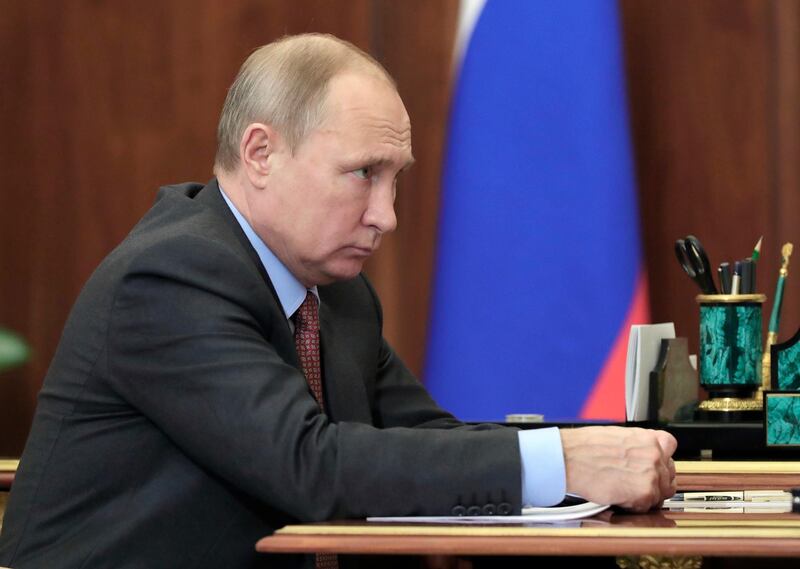Russian President Vladimir Putin listens to Russian Roscosmos head Dmitry Rogozin during a meeting in the Kremlin in Moscow, Russia, Monday, Feb. 4, 2019. Rogozin reported that Roscosmos plans to double the number of space launches this year compared to 2018. (Mikhail Klimentyev, Sputnik, Kremlin Pool Photo via AP)