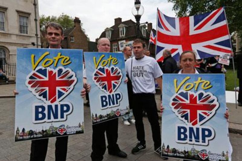 Members of the British National Party hold placards during a demonstration in central London on Saturday. AP Photo