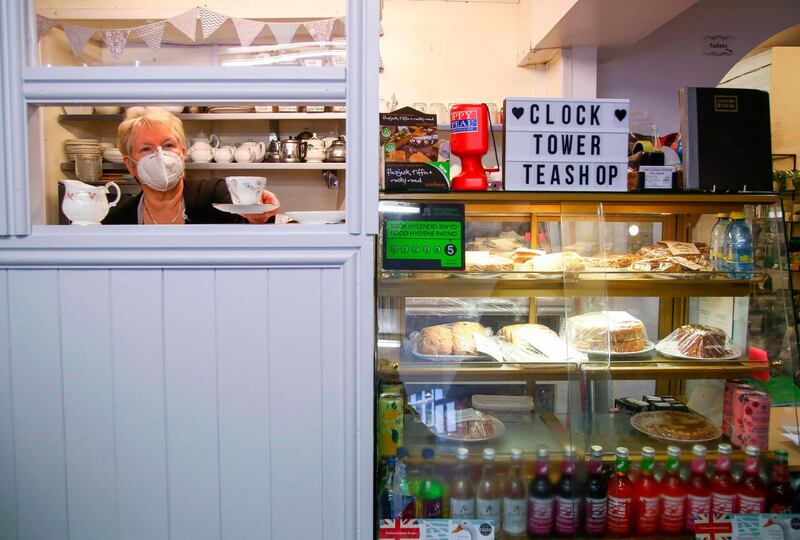 Chris Brandford serves teas and coffees in the Clock Tower Tea Shop. AFP