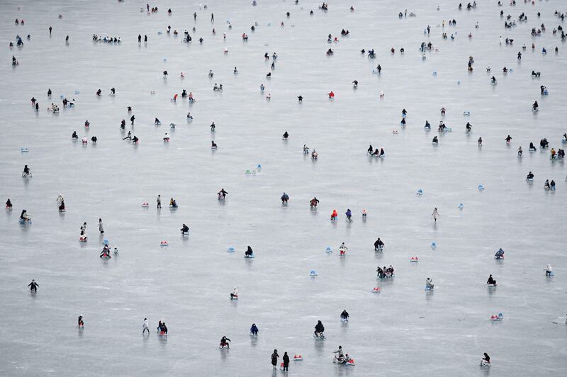 People sledding on a frozen lake near the Summer Palace in Beijing, China. AFP

