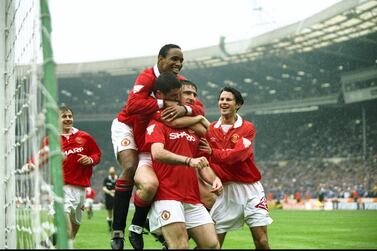 Manchester United players congratulate Eric Cantona, centre, after the Frenchman scored in his side's 4-0 win over Chelsea in the 1994 FA Cup final. Allsport UK