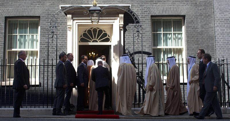 Members of the Emirati President Sheikh Khalifa bin Zayed al-Nahayan's delegation file into 10 Downing Street in central London on May 1, 2013 for a meeting with Britain's Prime Minister David Cameron. The UAE president was to face questions from Prime Minister David Cameron over allegations that three British men jailed in Dubai were tortured. Sheikh Khalifa bin Zayed al-Nahyan, head of state of the United Arab Emirates, will hold talks with Cameron at his Downing Street office on the second day of a two-day state visit to Britain.  AFP PHOTO / ANDREW COWIE
 *** Local Caption ***  027374-01-08.jpg