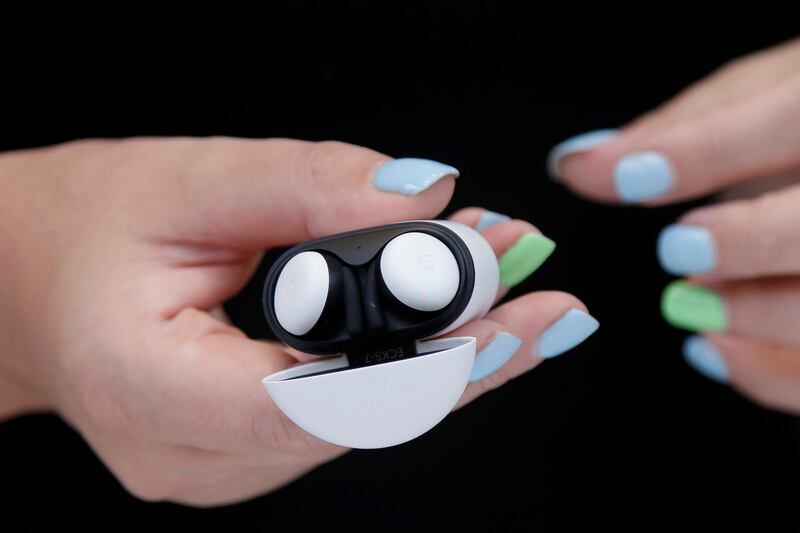 FILE - In this Sept. 24, 2019, file photo Isabelle Olsson, head of color & design for Nest, shows the Pixel buds in a case at Google in Mountain View, Calif. Alphabet Inc., parent company of Google reports financial earns on Monday, Oct. 28. (AP Photo/Jeff Chiu, File)