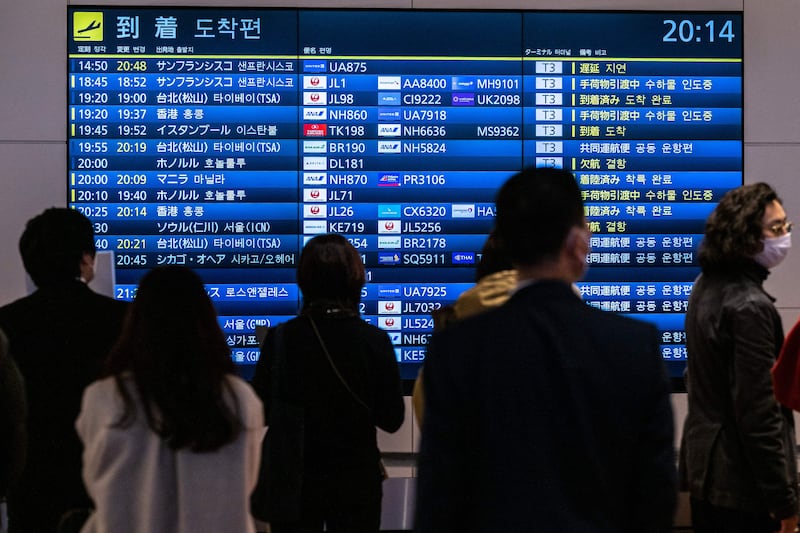 A board showing international flight arrivals at Tokyo's Haneda international airport. The world’s airlines are taking a cautious approach to China’s reopening. AFP