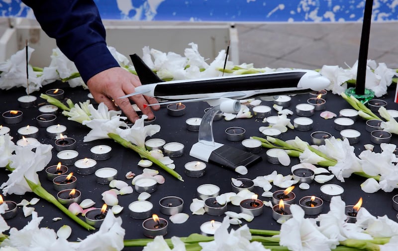 Students light candles during a memorial ceremony for passengers of Ukraine airplane at the Tehran university. EPA