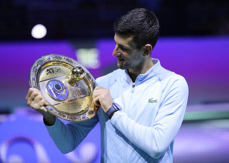 Novak Djokovic celebrates with the trophy after winning the Astana Open against Greece's Stefanos Tsitsipas on October 9. Reuters