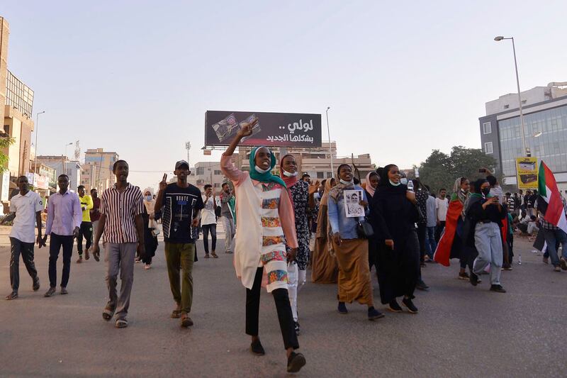Protesters march along 60th Street in Khartoum. AFP