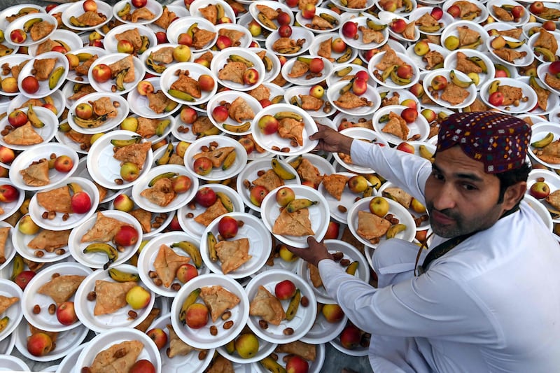 A volunteer prepares iftar food at the Data Darbar shrine in Lahore, Pakistan. AFP