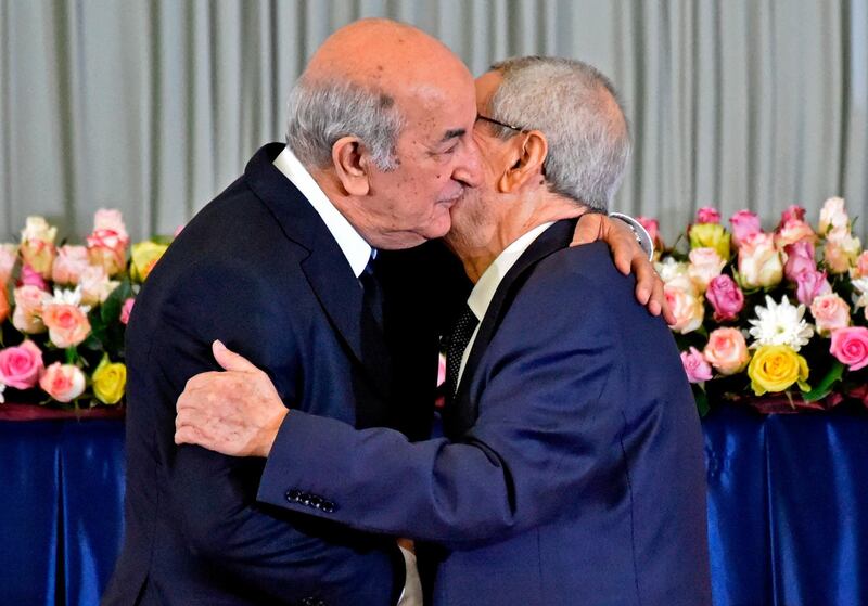 Algerian President-elect Abdelmadjid Tebboune (L) greets interim president Abdelkader Bensalah (R) during the formal swearing-in ceremony in the capital Algiers on December 19, 2019. The 74-year-old Tebboune, a former prime minister seen as close to the country's powerful military chief, reportedly garnered 58.13 percent of votes in the first ballot of a highly contested presidential election, according to the announced final results. He said after his victory he was ready for dialogue with a months-long protest movement that toppled his predecessor Abdelaziz Bouteflika. / AFP / RYAD KRAMDI                        
