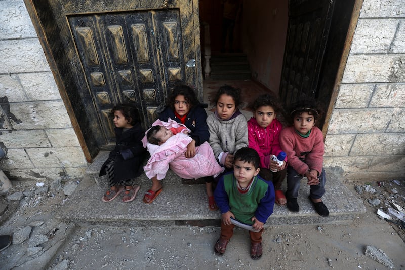 Palestinian children look at the site of an Israeli strike on a house. Reuters