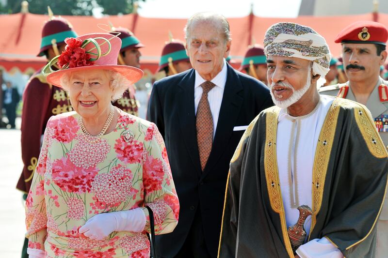 Queen Elizabeth walks towards her plane with former Sultan of Oman Qaboos bin Said Al Said, at Muscat Airport in November 2010. Getty Images