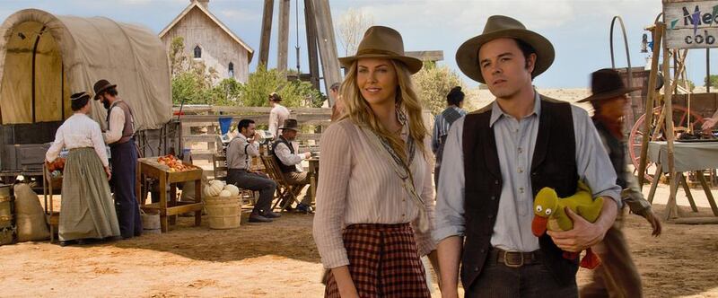 A handout movie still showing Anna (CHARLIZE THERON) and Albert (SETH MACFARLANE) try not to die at the fair in A Million Ways to Die in the West, the new comedy from director, producer and co-writer MacFarlane, who plays a formerly cowardly sheep farmer who must put his newfound courage to the test. (Courtesy: Universal Pictures)