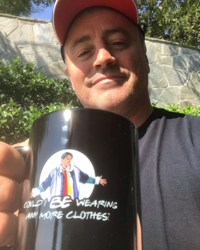Matt LeBlanc, who played Joey in 'Friends', holds a 'Could I be wearing any more clothes' mug from the limited edition Cast Collection of merchandise